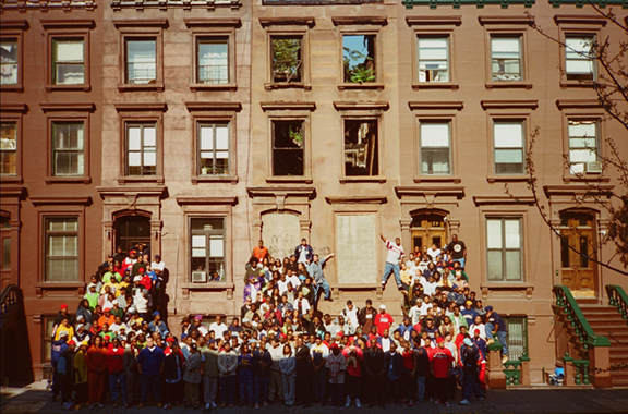 : Photo of hip-hop artists gathered on Harlem stoop