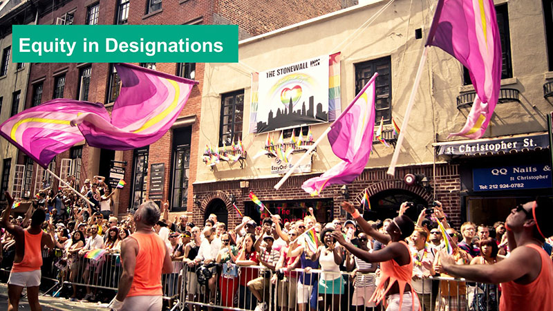 A parade taking place infront of the Stonewall Inn