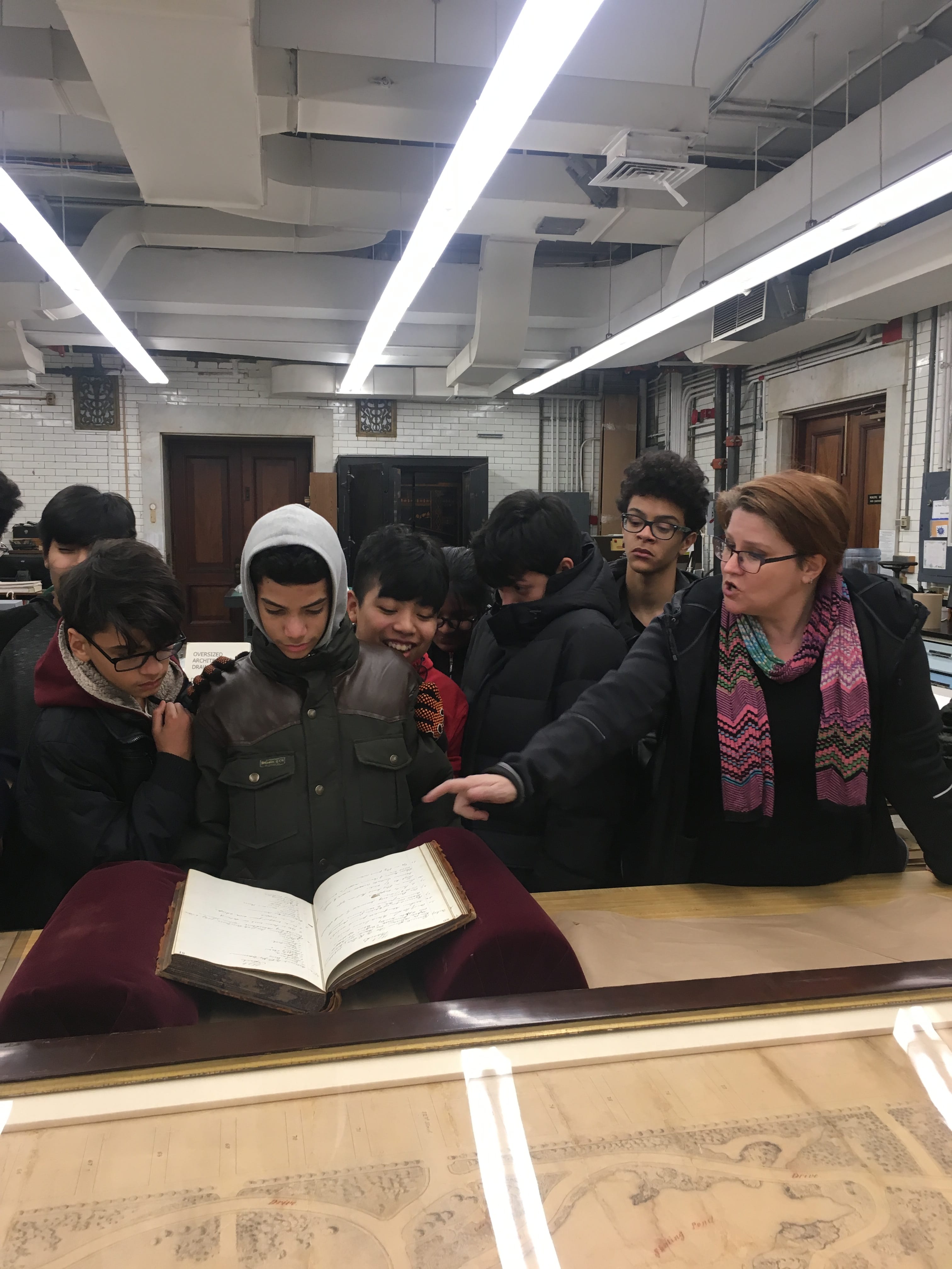 High School Students looking at documents in the Municipal Archives Conservation Lab.
