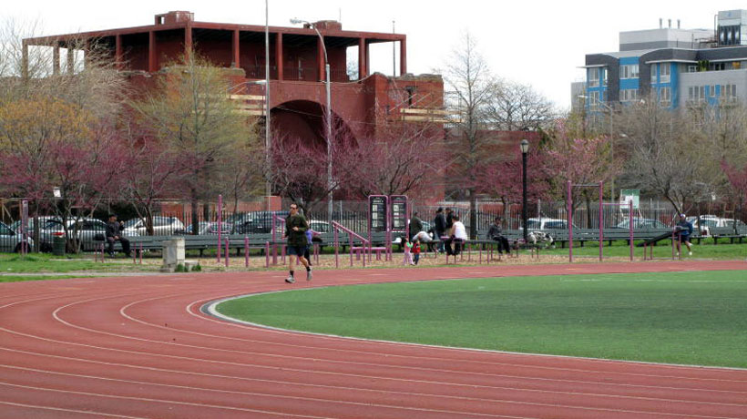 man running the track at McCarren Park in the day
                                           