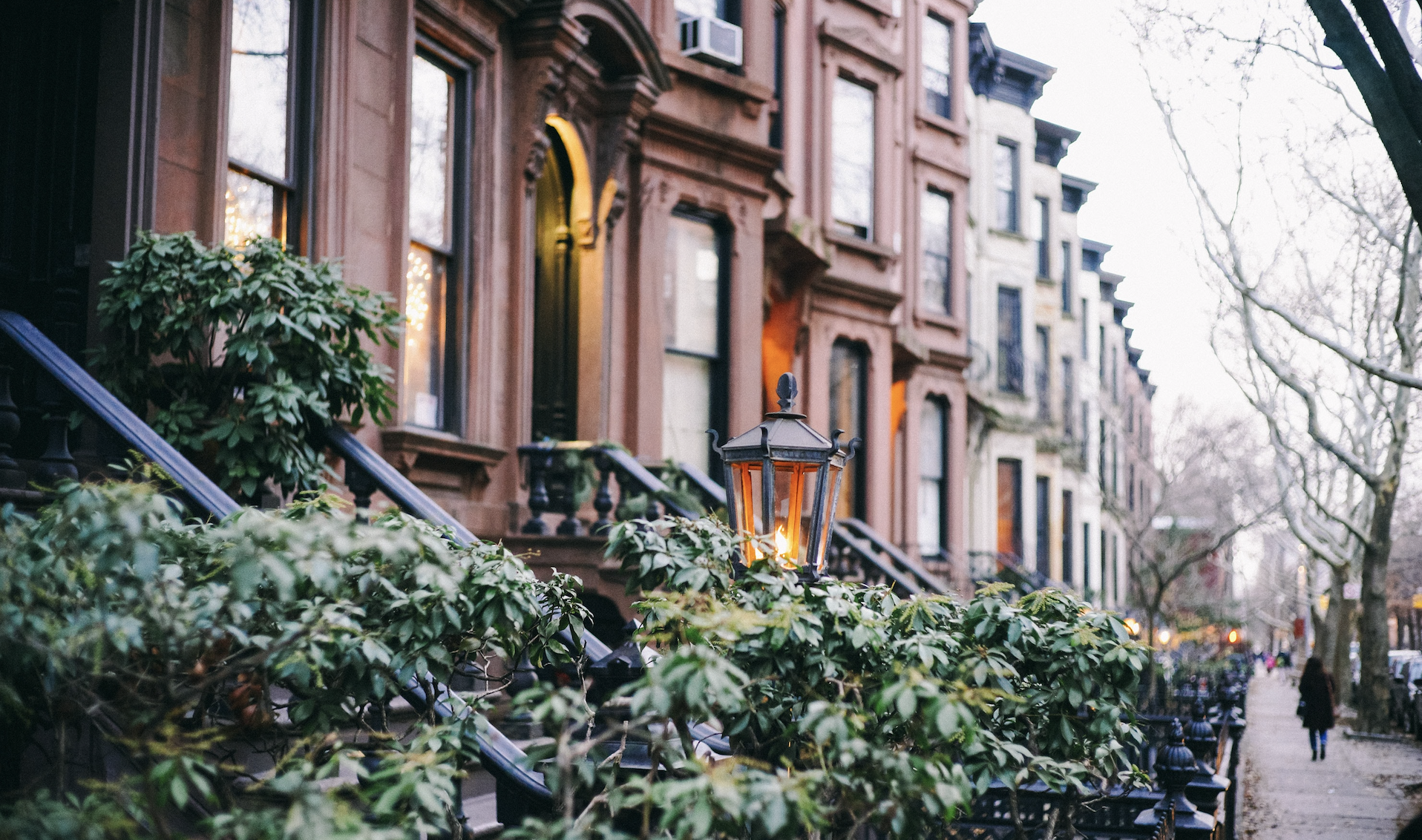 New York street, with emphasis on brownstone homes and greenery.