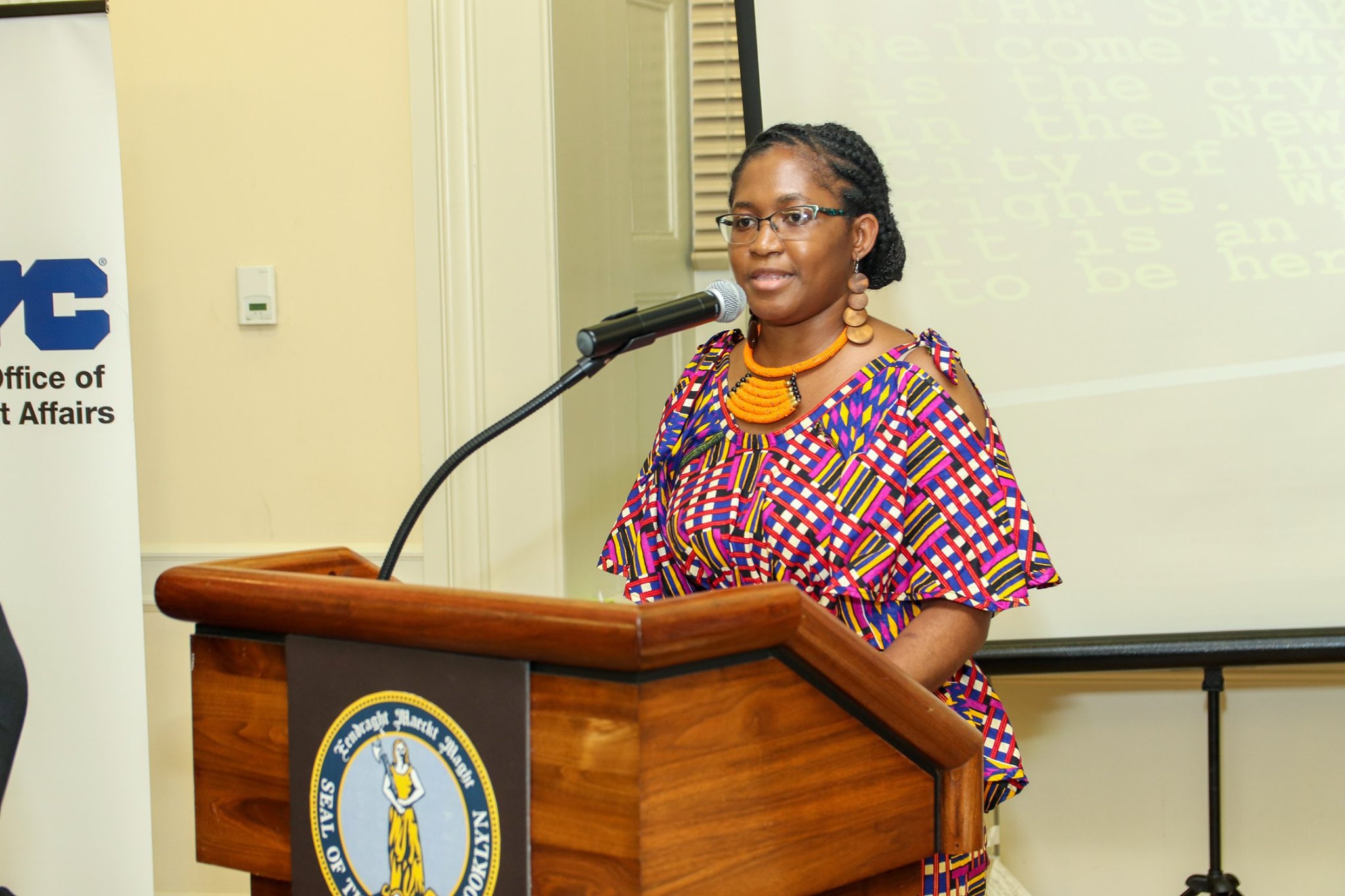 Christelle Onwu speaking at a podium.