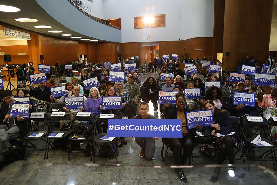 Group photo with census volunteers with 'Get Counted' signs