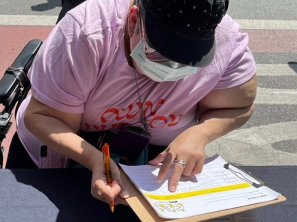 a person filling out a form at the outreach desk