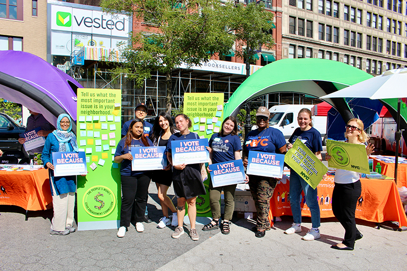 Group photo of CEC staff holding signs about the importance of voting