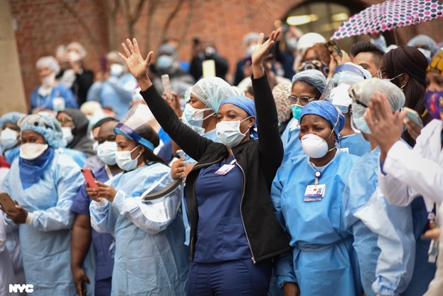 a group of healthcare workers and hospital nurses cheering