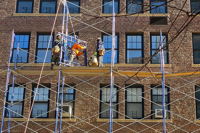 Construction workers on scaffolding.
                                           