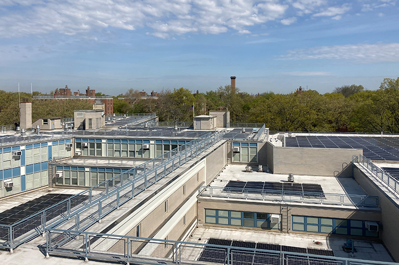 An image of a school rooftop with solar panels installed.