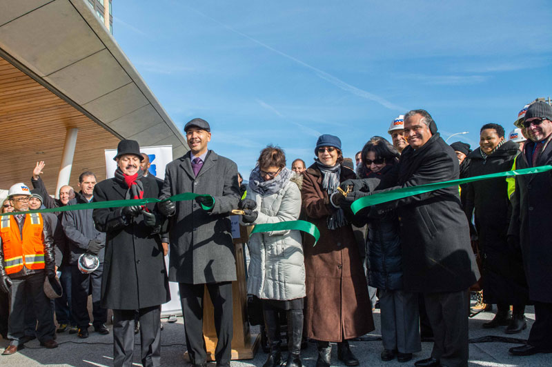 Commissioner Peña-Mora and other officials cutting the ribbon for Fordham Plaza.
