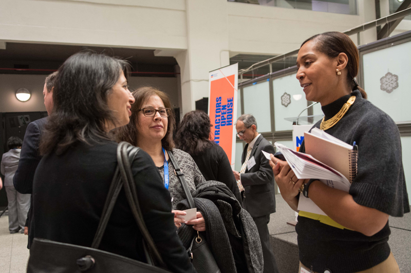 Chief Diversity and Industry Relations Officer Maggalie Austin talks with two attendees.