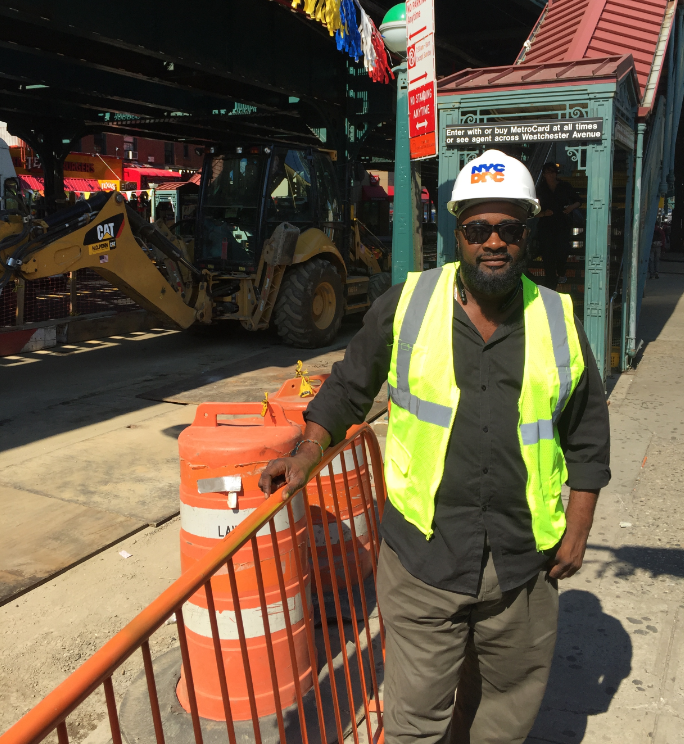 DDC Resident Engineer Erickson Prevost in front of a bus bump-out