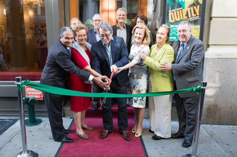 Commissioner Peña-Mora and Irish Rep supporters cut a ribbon to signify the reopening of the theater.