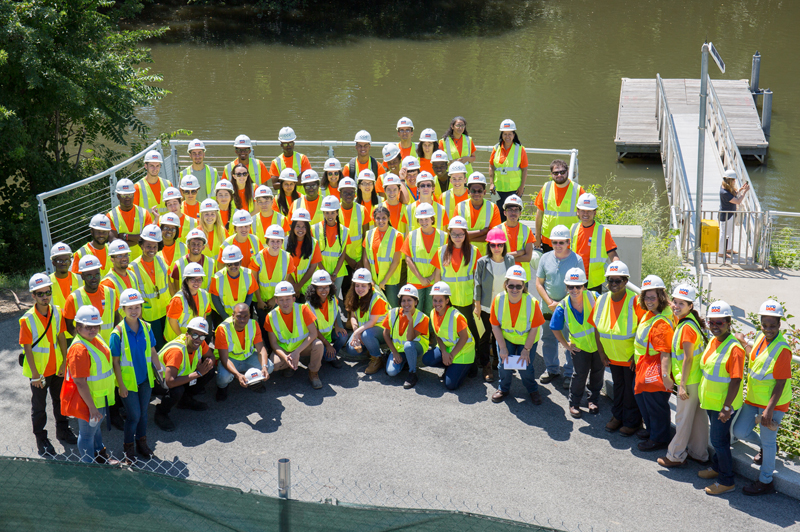 DDC Project Managers lead College and High School interns pose for a group photo in Starlight Park.