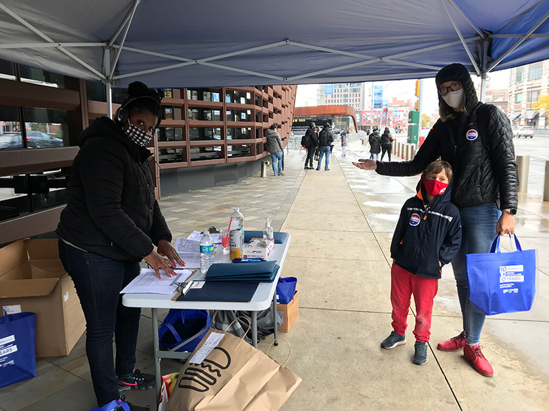 city employee handing out materials to an Elections Observers Corps volunteer