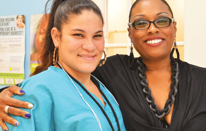 A former shelter resident (near right, with a case manager at the Kensington Shelter in Brooklyn) moved out with rental assistance from one of the City's new programs, CityFEPS.