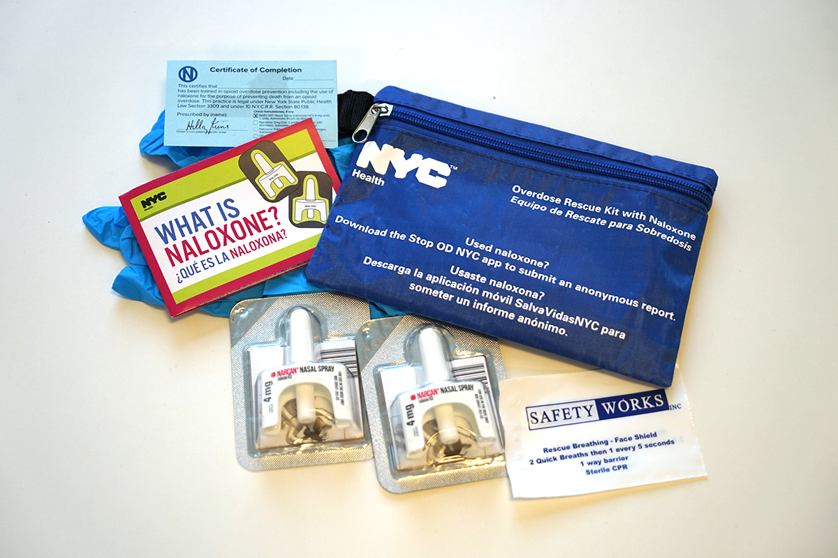 Several items that are part of the Health Department’s naloxone kit, including two doses of naloxone, gloves, an educational insert and a face shield.