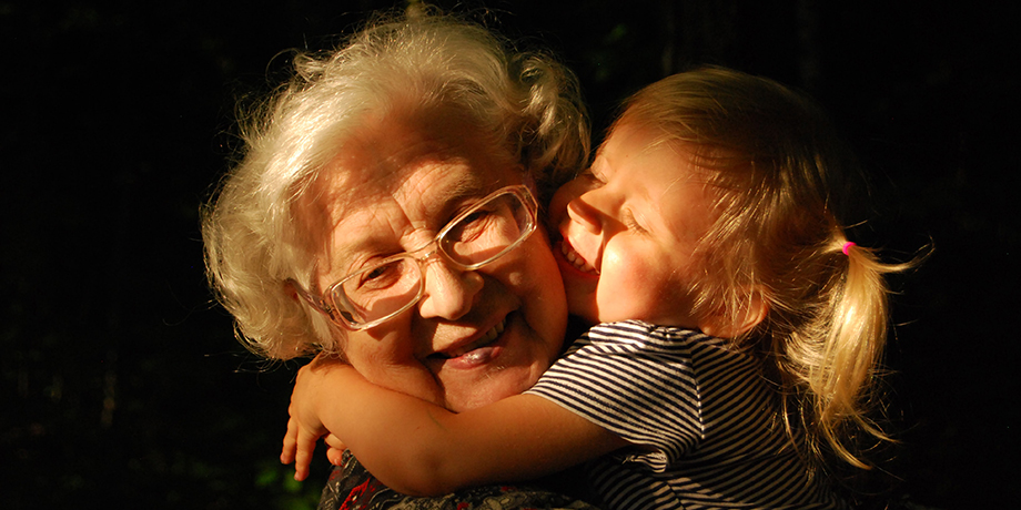 Grandbaby hugging her smiling grandmother
                                           