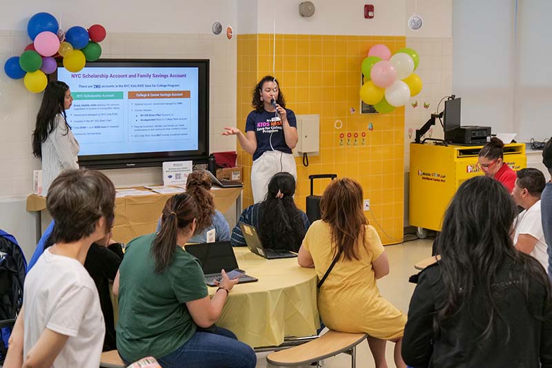Alejandra Sanchez, Community Engagement Associate, and Elisa Mateo-Saja, Community Engagement Manager, leading an information session to P.S. 398Q families on the NYC Kids RISE Save for College Program.