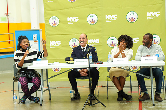 The Bronx community engaging with the cannabis panel while City representatives New York City's Sheriff Anthony Miranda, NYC Mayor's Office of Equity Commissioner Sideya Sherman and Small Business Services Commissioner Kevin Kim look on.