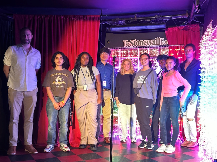 SYEP Pride participants gather on stage at the Stonewall Inn for a photo with Acting Executive Director of the Unity Project Ronald Porcelli and Co-Owner of the Stonewall Inn Stacy Lentz. 
