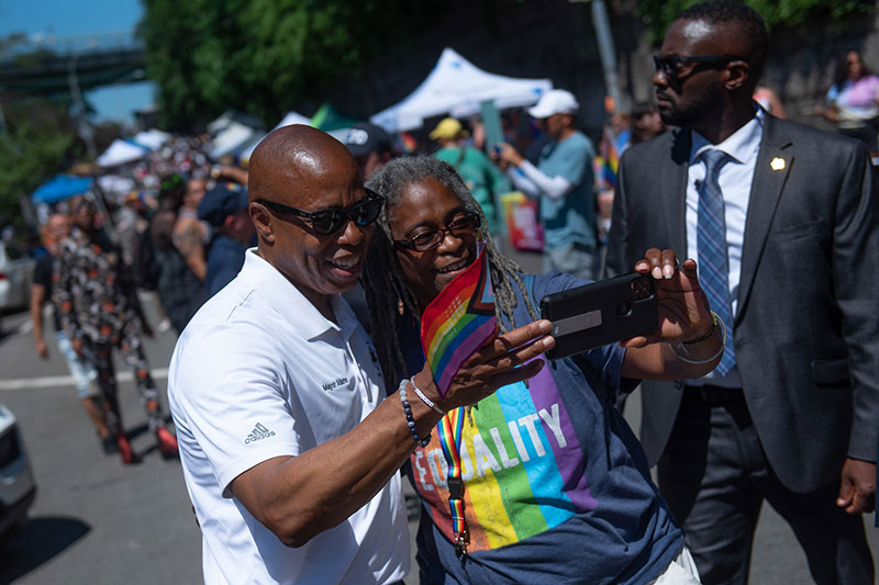 Mayor Eric Adams takes a picture at Harlem Pride.