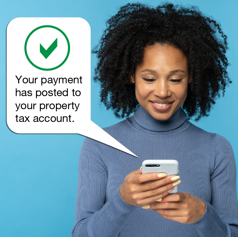 Image of a woman using a mobile device and a speech bubble with the words 'Your payment has posted to your property tax account'