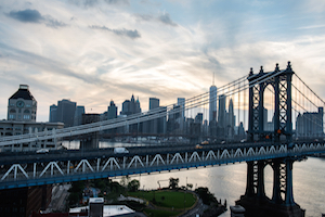 Manhattan Bridge with the NYC skyline behind it