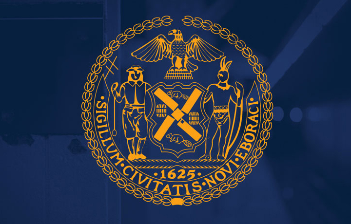 Gold NYC seal on blue background.
                                           