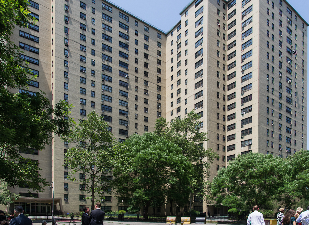 Tall 1,105-unit building complex with trees in front.
