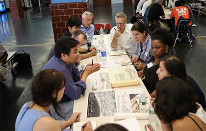 People gathered around a table discussing ideas