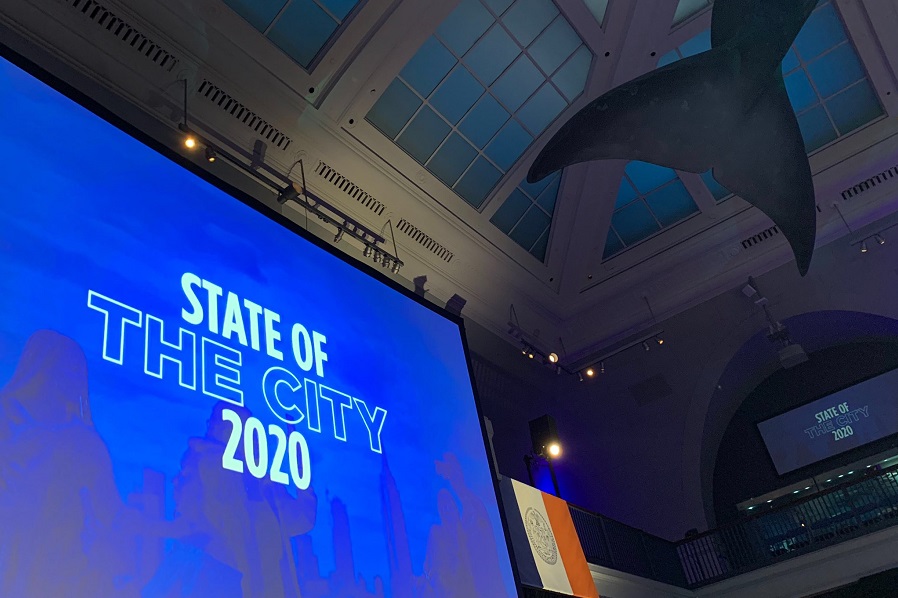 Screen showing State of the City logo in the Museum of Natural History