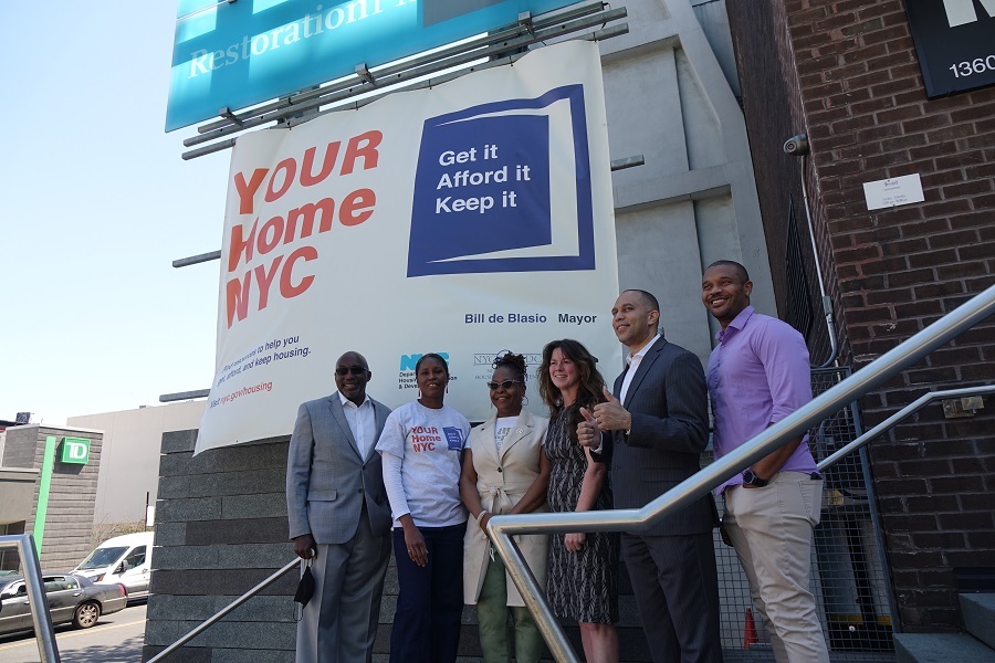 HPD and electeds in front of the Your Home NYC banner