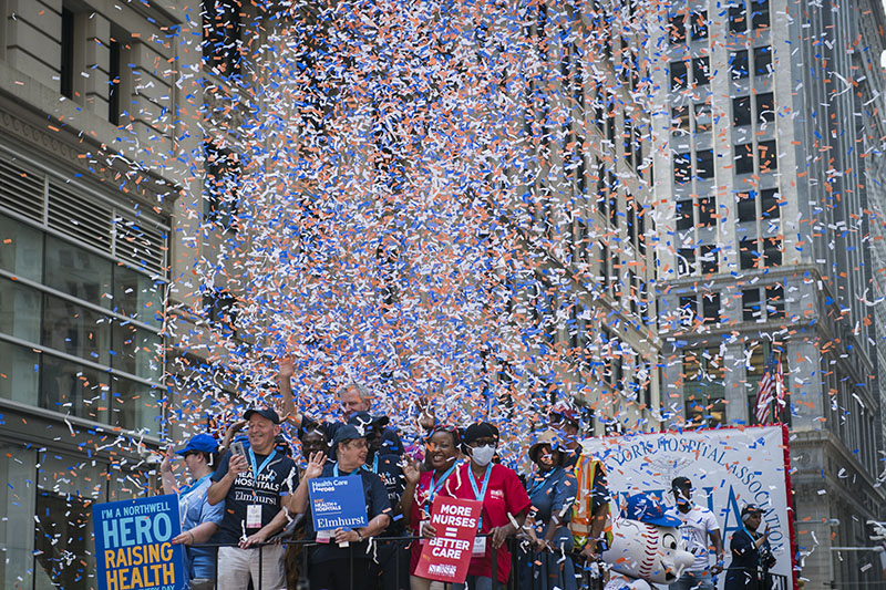 Confetti falling on the float the Mayor is riding along with five people from New York City Health + Hospitals.