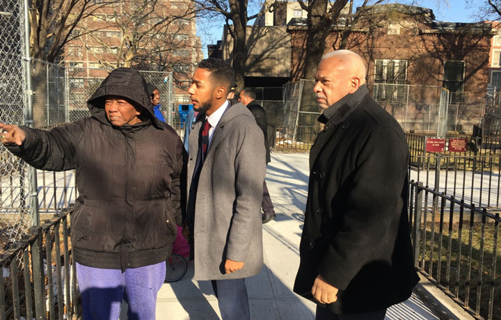 General Manager Michael Kelly and Council Member Antonio Reynoso explore the site of the new playground with a female NYCHA resident.