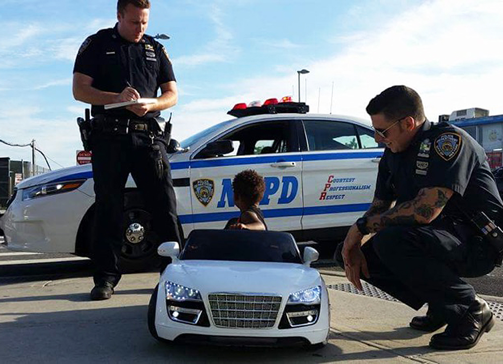 Officers from the 108 Precinct in Queens review the rules of the road with a young motorist