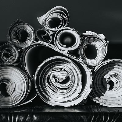Several rolls of newspapers on a table 