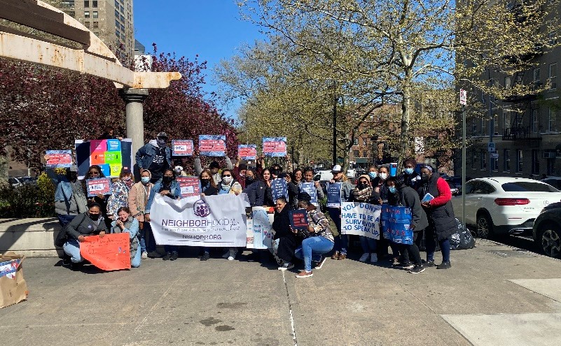 Large group dressed in denim holding Denim Day signs and banners in Mount Eden, Bronx NY.
