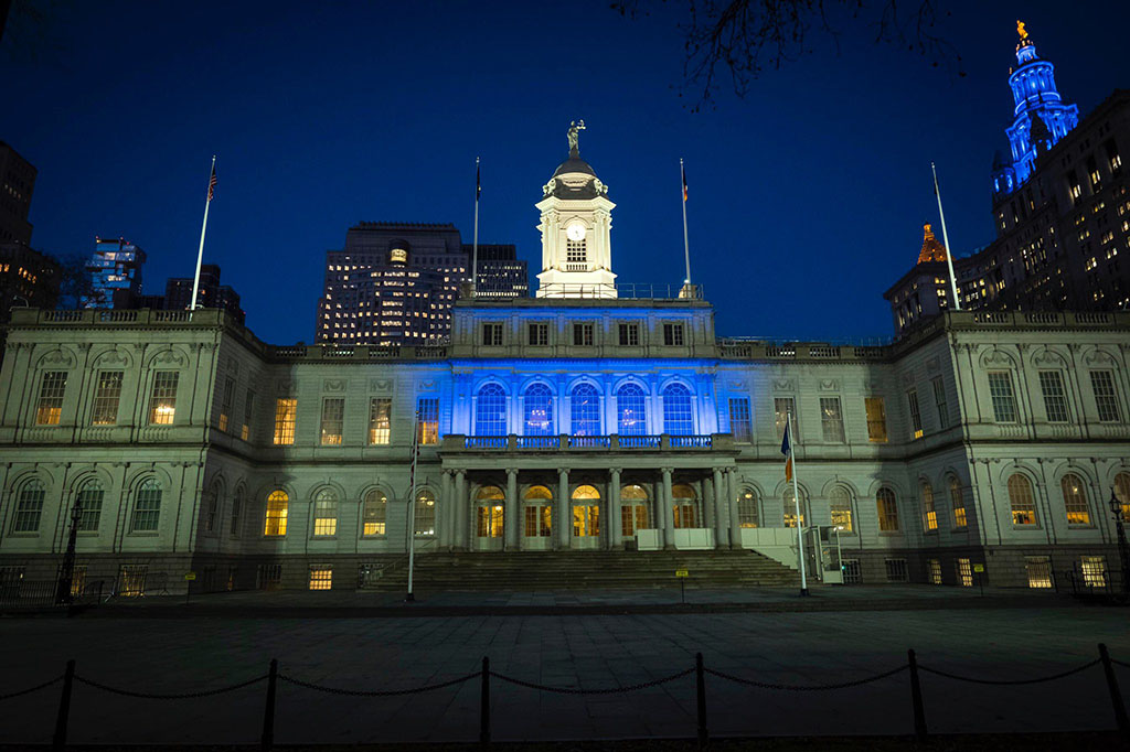 City Hall building with blue light on it facade