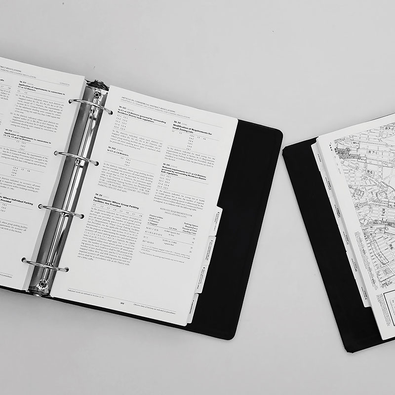 Open binders with text and maps