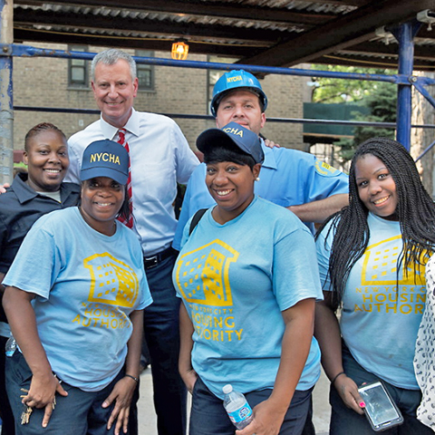 NYCHA employees posing with the Mayor