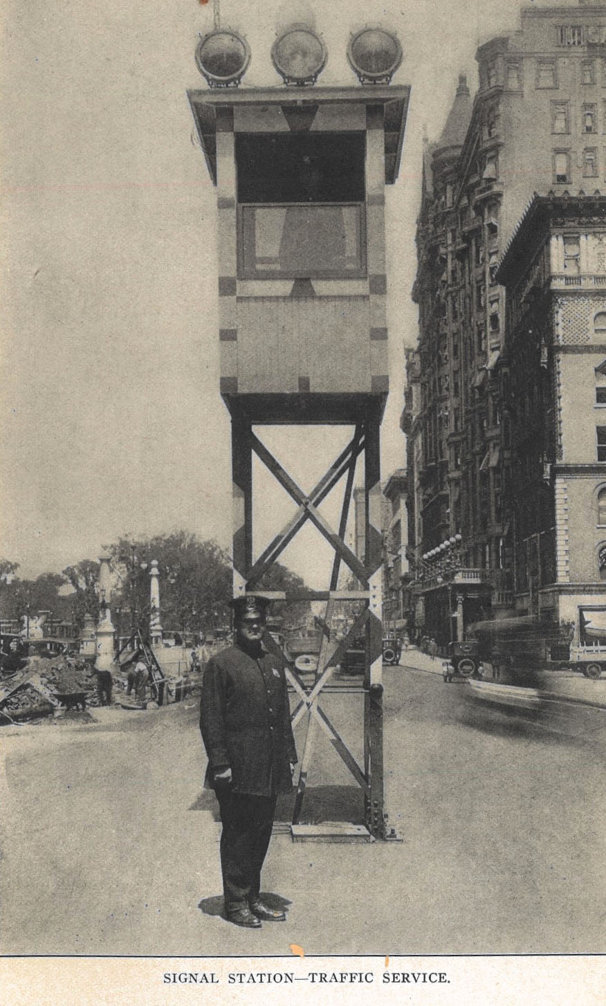 Historic photo of a policeman standing infront of a signal station in 1918.