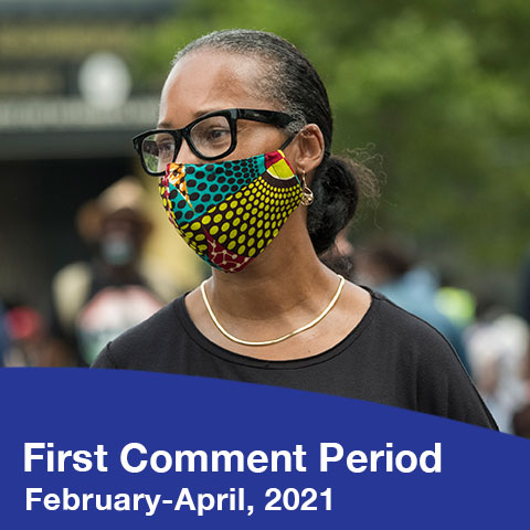 A Black woman wearing a mask of colorful prints that resemble traditional African textiles. The text reads First Comment Preiod - February-April, 2021