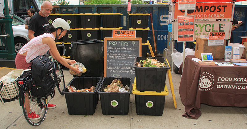 Woman dropping off food scraps at a compost site