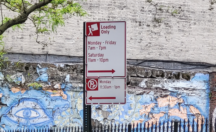 White and red “Loading Only” signs designate areas where only loading is allowed at specific times.