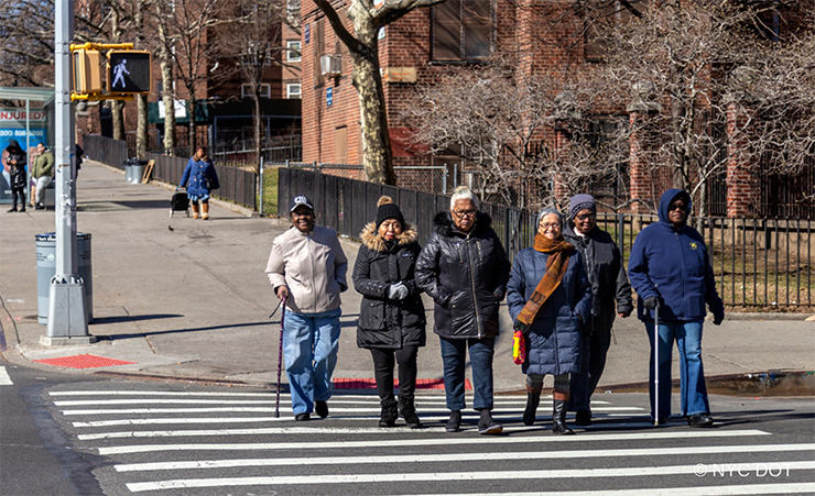 Six senior pedestrians cross the crosswalk at Tinton Avenue in the Bronx.
