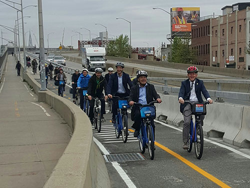 Bikers riding over protected bikeway on the Pulaski Bridge