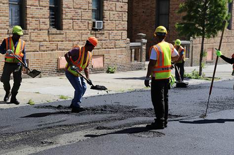 NYC DOT crew fills a pothole
