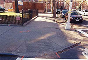 Before photo of the sidewalk ramps outside South Jamaica Houses